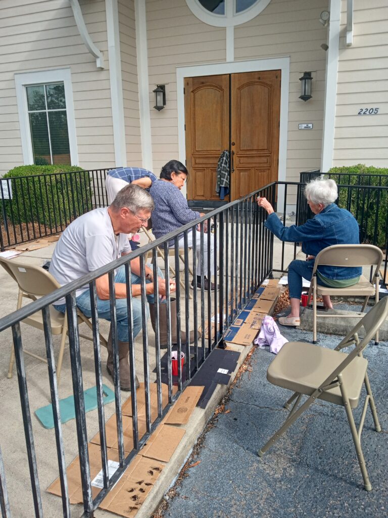 St Ann Cursillo gives the front railings a fresh coat of paint.